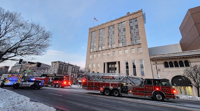 Hamilton police and fire crews respond to the First Financial Bank building at North Third and High streets for a reported fire after seeing smoke. Fire crews determined it was steam from the HVAC system flowing in cold weather. NICK GRAHAM/STAFF