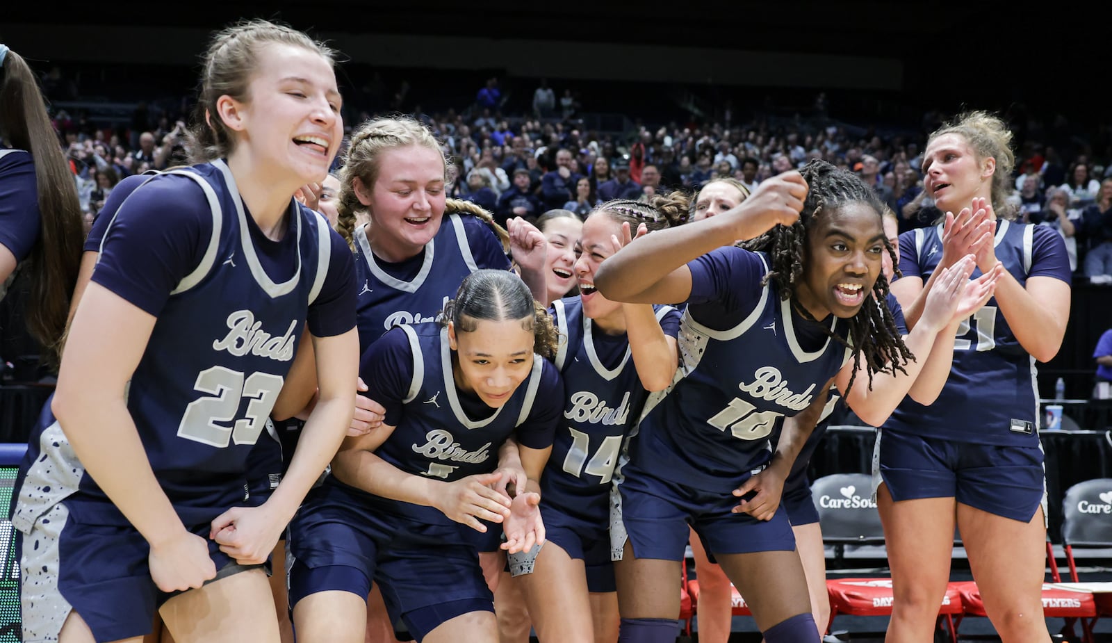 Fairmont sophomore guard Janiyah Hargrave (center left) leads a celebration in front of the team's bench following a 61-55 overtime win over Princeton in the Division I state final on Saturday, March 15 at University of Dayton Arena. Hargrave led the squad with 23 points and nine rebounds. BRYANT BILLING / STAFF