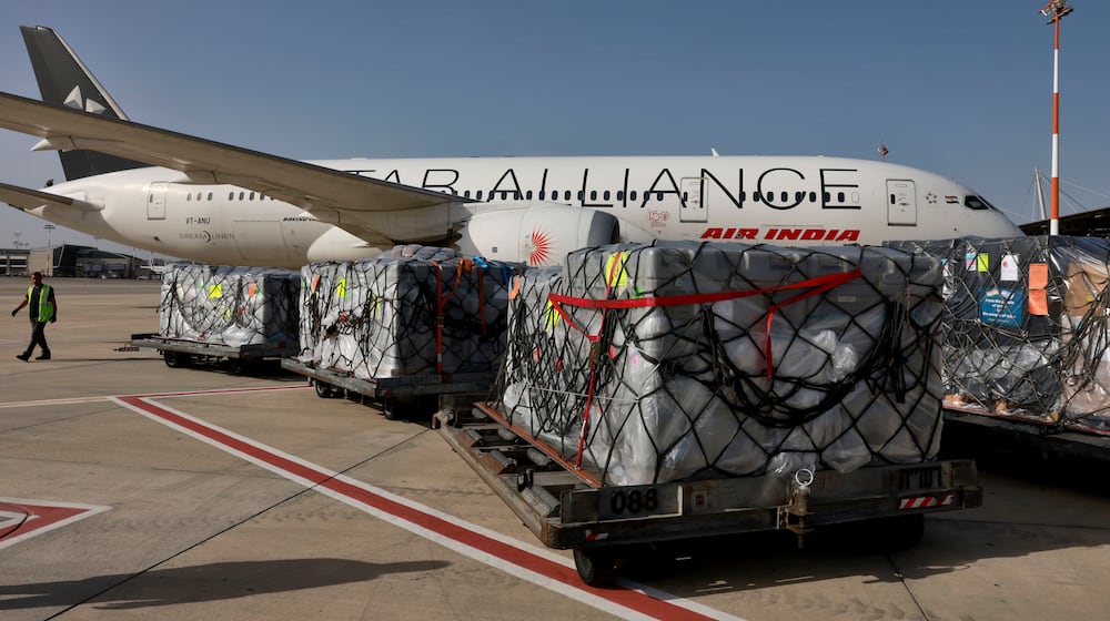 FILE -Workers load medical aid onto an Air India plane to be flown to India, at Ben Gurion Airport near Tel Aviv, Israel, May 4, 2021. (Menahem Kahana/Pool Photo via AP, File)