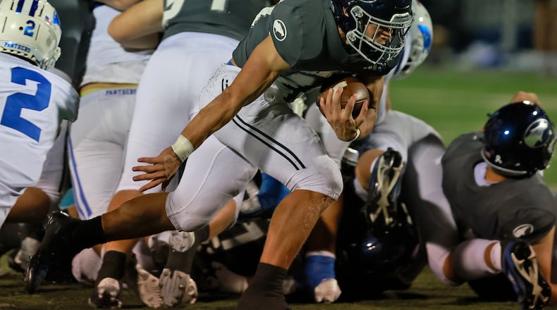 Fairmont's Logan Doty breaks through the Springboro defense on his way to a touchdown. BILL LACKEY/STAFF