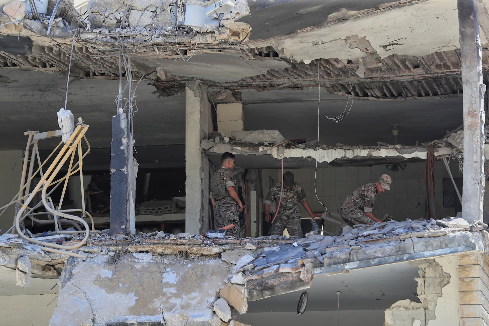 Lebanese army soldiers inspect a destroyed house that was hit in an Israeli airstrike in Nabatieh town, south Lebanon, Friday, June 27, 2025. (AP Photo/Mohammed Zaatari)
