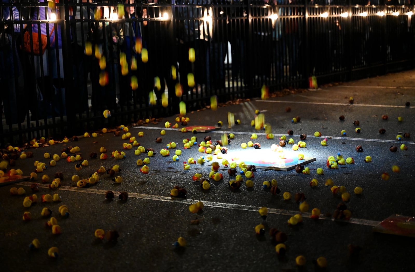 The annual Hamilton Turkey Drop raised more than $3,000 in its second year for the Butler County Veterans Memorial Wall project. There were 470 ducks sold, selling more than initially intended, for this year's pre-Thanksgiving event that celebrates the famous 1978 "WKRP in Cincinnati" turkey drop episode. In its inaugural year, the Hamilton Turkey Drop raised $2,000 for the project to update the memorial wall at Veterans Park. The ducks were dropped from a Hamilton Fire Department ladder truck onto one of five targets. One person won $500 and four won $100. Pictured is Municipal Brew Works co-owner Jim Goodman measuring the proximity of a duck near one of the five targets. MICHAEL D. PITMAN/STAFF