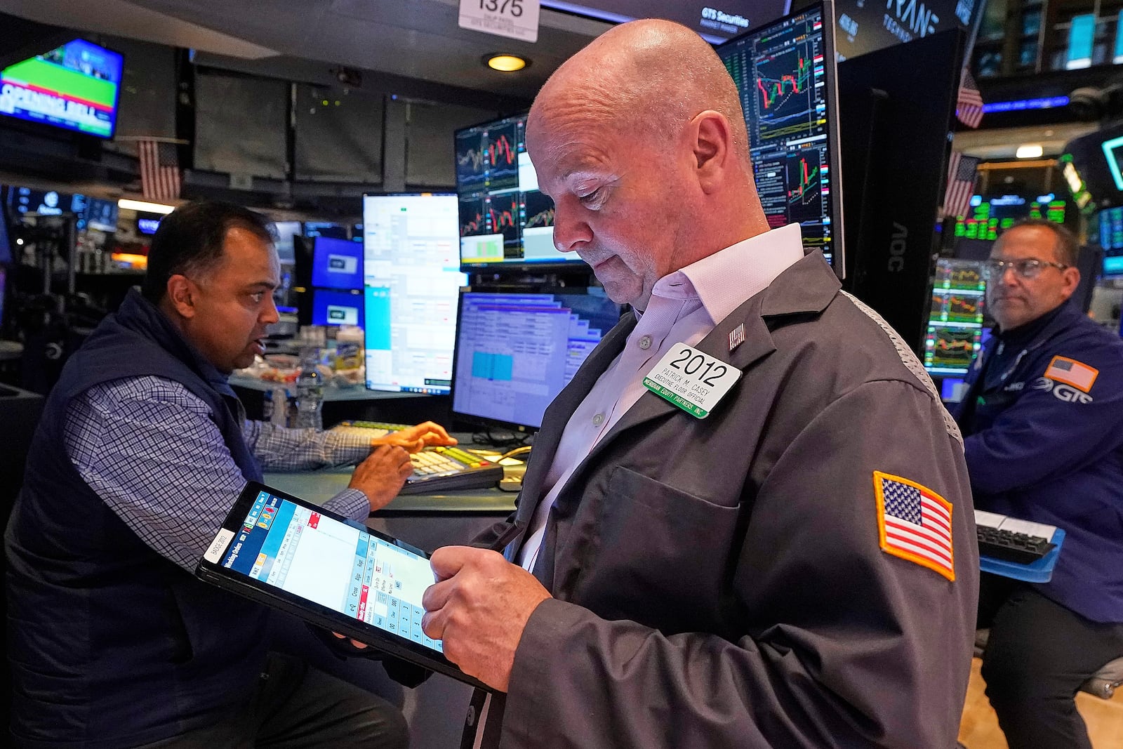 Trader Patrick Casey, center, works on the floor of the New York Stock Exchange, Thursday, May 8, 2025. (AP Photo/Richard Drew)