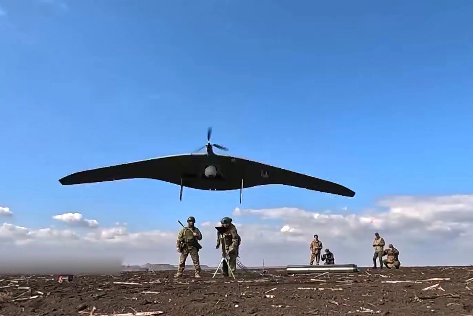 In this photo taken from video distributed by Russian Defense Ministry Press Service on Friday, April 18, 2025, Russian soldiers launch a Supercam intelligence unmanned aerial vehicle towards Ukrainian positions in Ukraine. (Russian Defense Ministry Press Service via AP)