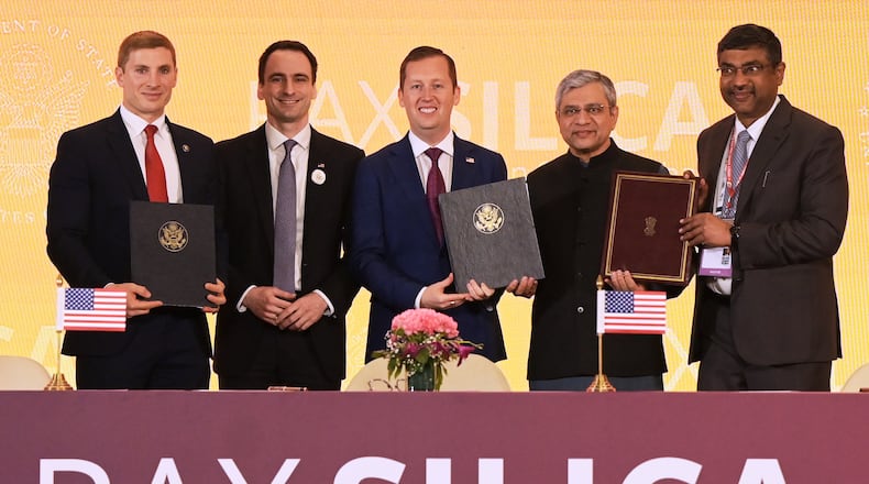 India's IT Minister Ashwini Vaishnaw, second right, poses for a photograph with U.S. Ambassador to India Sergio Gor, center, U.S. Under Secretary of State for Economic Affairs Jacob Helberg, first left, and other officials after signing an agreement in New Delhi, India, Friday, Feb. 20, 2026. (AP Photo)