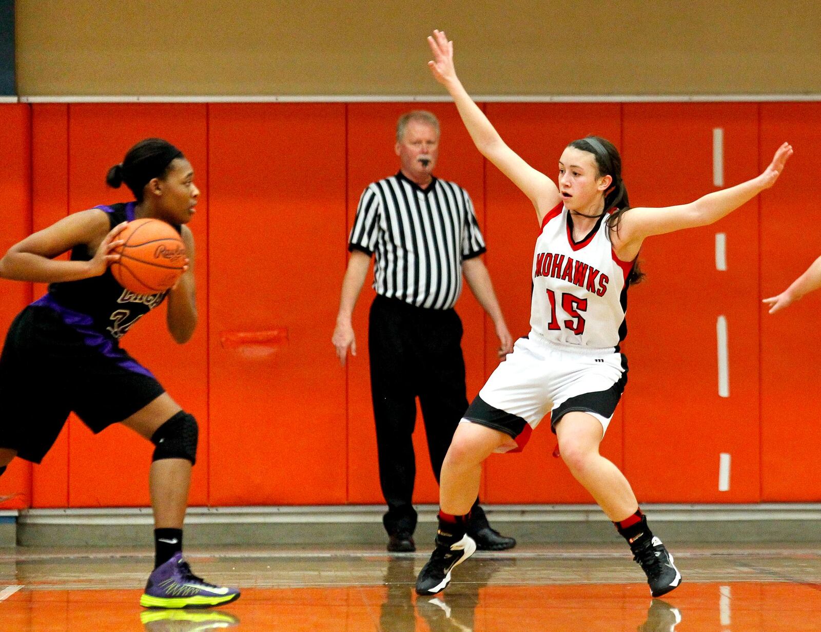 Madison’s Hunter Whiteman (15) defends Cincinnati Hills Christian Academy’s Kennedi Toney (34) during a Division III sectional game on Feb. 18, 2014, at Wilmington. NICK DAGGY/STAFF