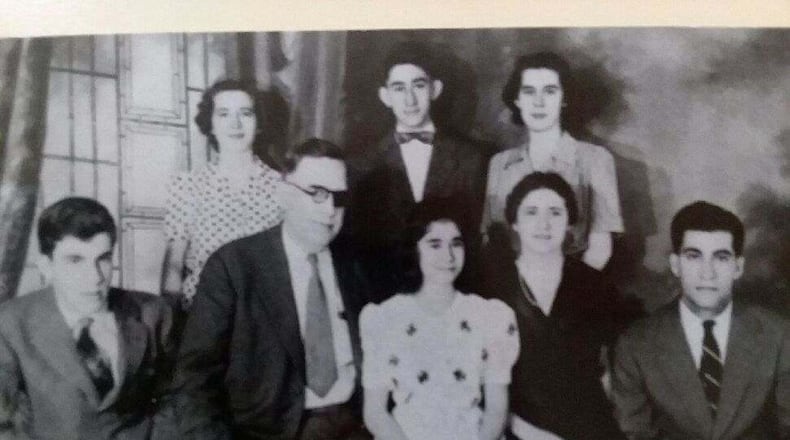 Albert B. Oberst, wearing an eye patch, gave a pocket watch to his son, Jim Oberst, middle back row. Oberst then gave the watch to his son, Albert Oberst. The watch was stolen 23 years ago during a home invasion, then it turned up recently in Middletown. SUBMITTED PHOTO