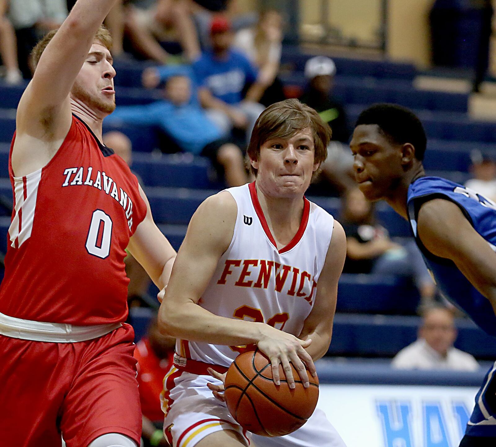 Fenwick’s John Engelmeier finds himself between Talawanda’s Evan James (0) and Hamilton’s Myles Howard during the inaugural All-Butler County All-Star boys basketball game at the Hamilton Athletic Center on Saturday. CONTRIBUTED PHOTO BY E.L. HUBBARD