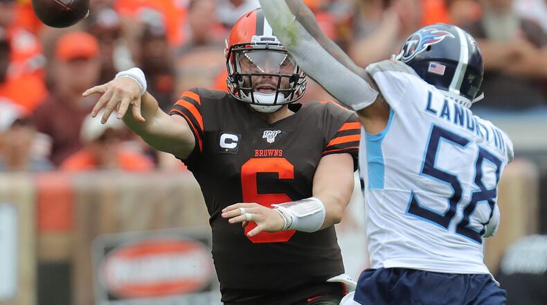 Cleveland Browns quarterback Baker Mayfield gets off a fourth quarter pass while being pressured by Tennessee Titans’ Harold Landry III on Sunday, Sept. 8, 2019 in Cleveland, Ohio, at FirstEnergy Stadium. The Browns lost the game 43-13. (Phil Masturzo/Akron Beacon Journal/TNS)