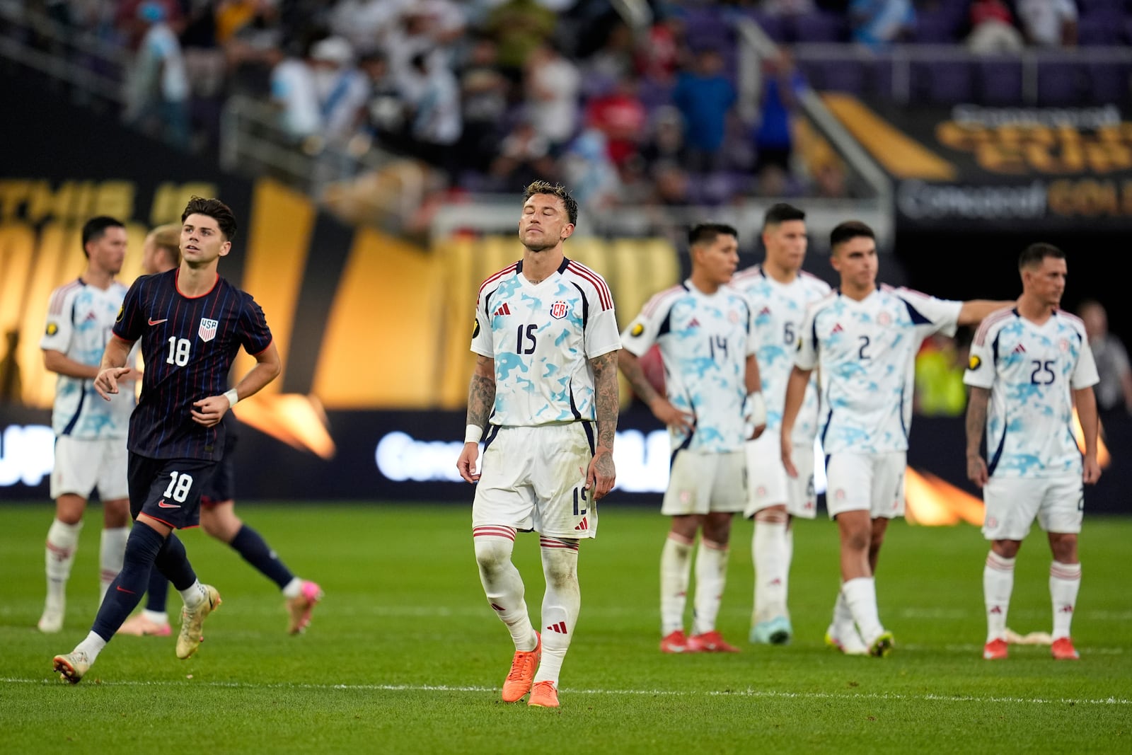 Costa Rica defender Francisco Javier Calvo Quesada (15) stands on the field with teammates after losing to the United states in penalty kicks of a CONCACAF Gold Cup quarterfinals soccer match, Sunday, June 29, 2025, in Minneapolis. (AP Photo/Abbie Parr)