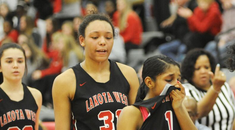 Nevaeh Dean (center) scored 24 points and Bryana Henderson (right) four for West. Centerville defeated Lakota West 67-55 in a girls high school basketball D-I district final at Princeton on Saturday, March 2, 2019. MARC PENDLETON / STAFF