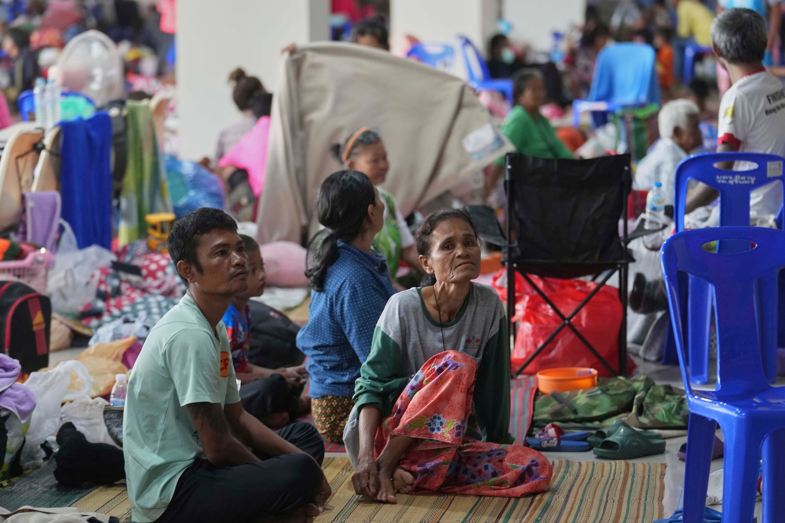 Thai residents who fled homes following clashes between Thai and Cambodian soldiers rest at an evacuation center in Surin province, Thailand, Sunday, July 27, 2025. (AP Photo/Sakchai Lalit)