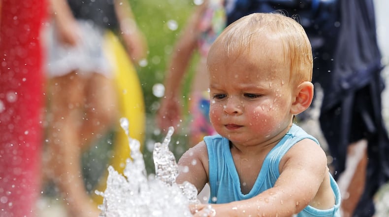 Samuel King, 1, plays in the water at the splash pad at Smith Park in Middletown Monday, June 17, 2024. NICK GRAHAM/STAFF