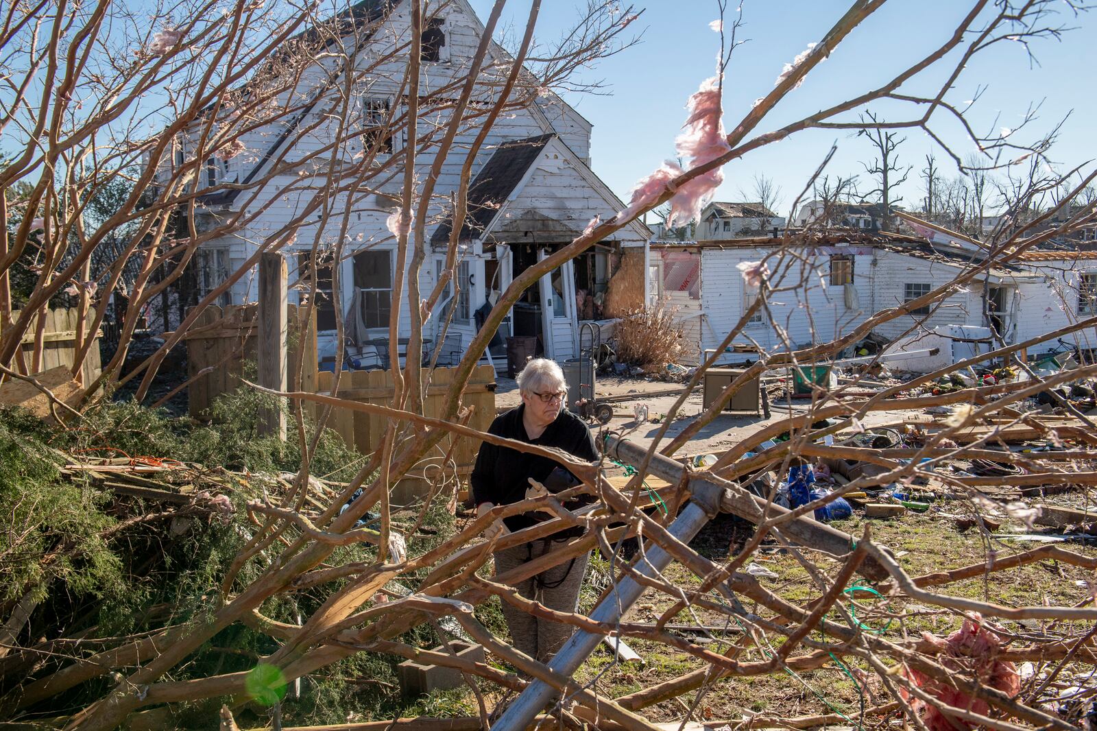 Martha Thomas surveys the damage around her home in Mayfield, Ky. on Monday, Dec. 13, 2021, after a tornado swept across the region days earlier. Determining how many people died in the tornadoes that ravaged the central U.S. on Friday has been a challenging task so far, with estimates fluctuating as search teams continue to spread out amid vast fields of rubble in an effort to rescue the living and account for the dead. (Johnny Milano/The New York Times)