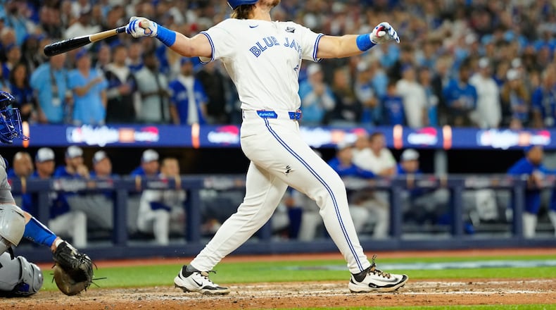 Toronto Blue Jays' Addison Barger watches his grand slam against the Los Angeles Dodgers during the sixth inning of Game 1 of baseball's World Series in Toronto, Friday, Oct. 24, 2025. (Frank Gunn/The Canadian Press via AP)