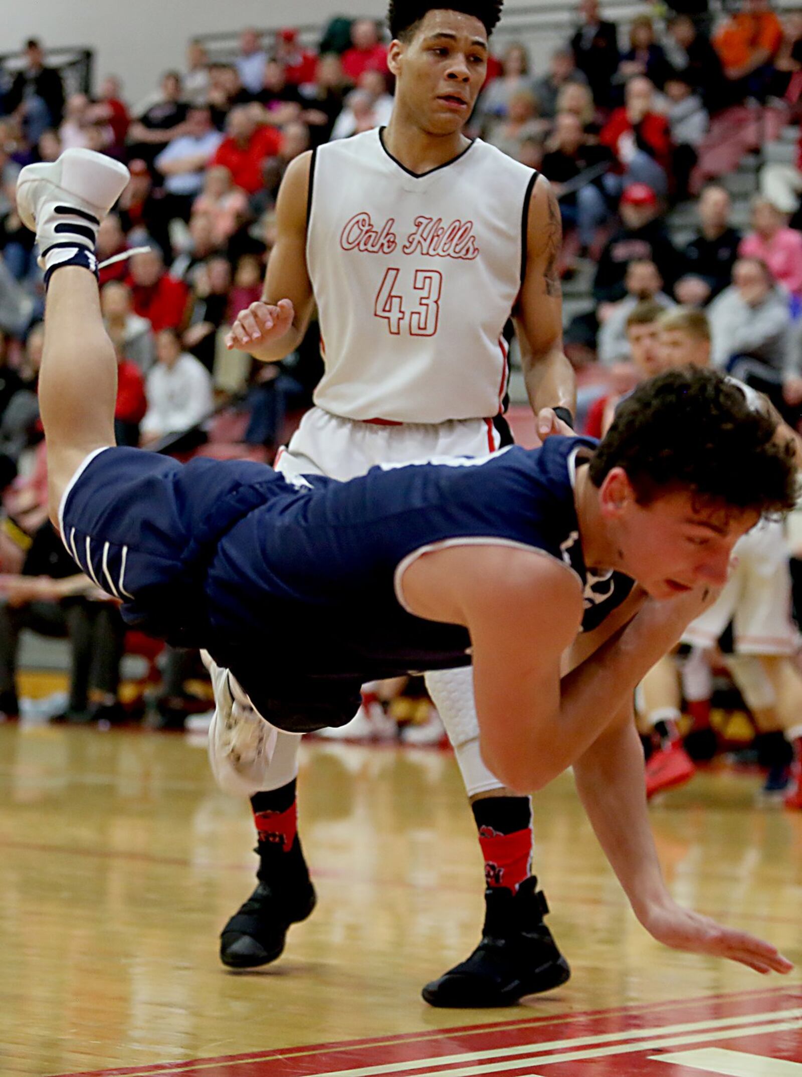 Oak Hills guard Ryan Batte watches Edgewood guard Nick Noble fly out of bounds during their Division I sectional contest at Fairfield Arena on Tuesday night. CONTRIBUTED PHOTO BY E.L. HUBBARD