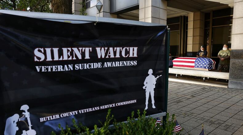 Volunteers stand watch over a flag draped casket as the Butler County Veterans Service Commission and volunteers held a Silent Watch for veteran suicide awareness Wednesday, Sept. 21, 2022 outside the Veterans Service Commission office on High Street in Hamilton. NICK GRAHAM / STAFF