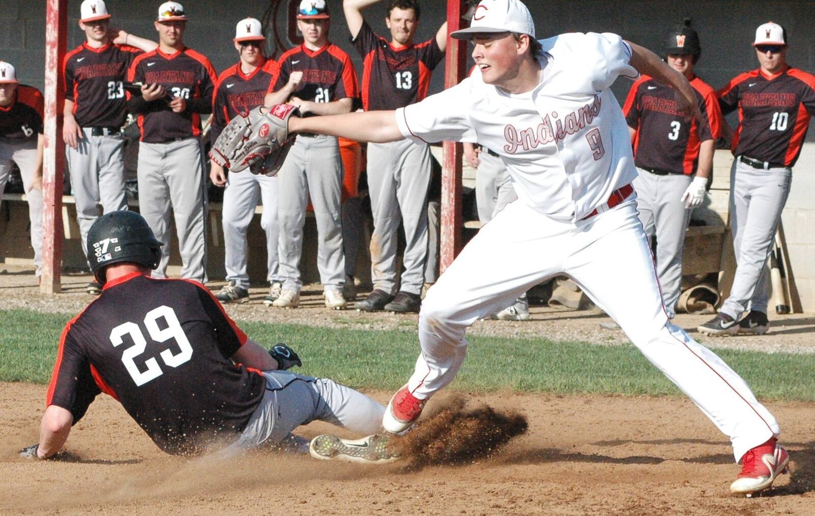 Carlisle pitcher Sam Rawlins (9) can’t stop Waynesville’s Ryan Papanek (29) from scoring on a wild pitch Monday during a Southwestern Buckeye League Buckeye Division baseball game at Sam Franks Field in Carlisle. Waynesville won 7-0. RICK CASSANO/STAFF