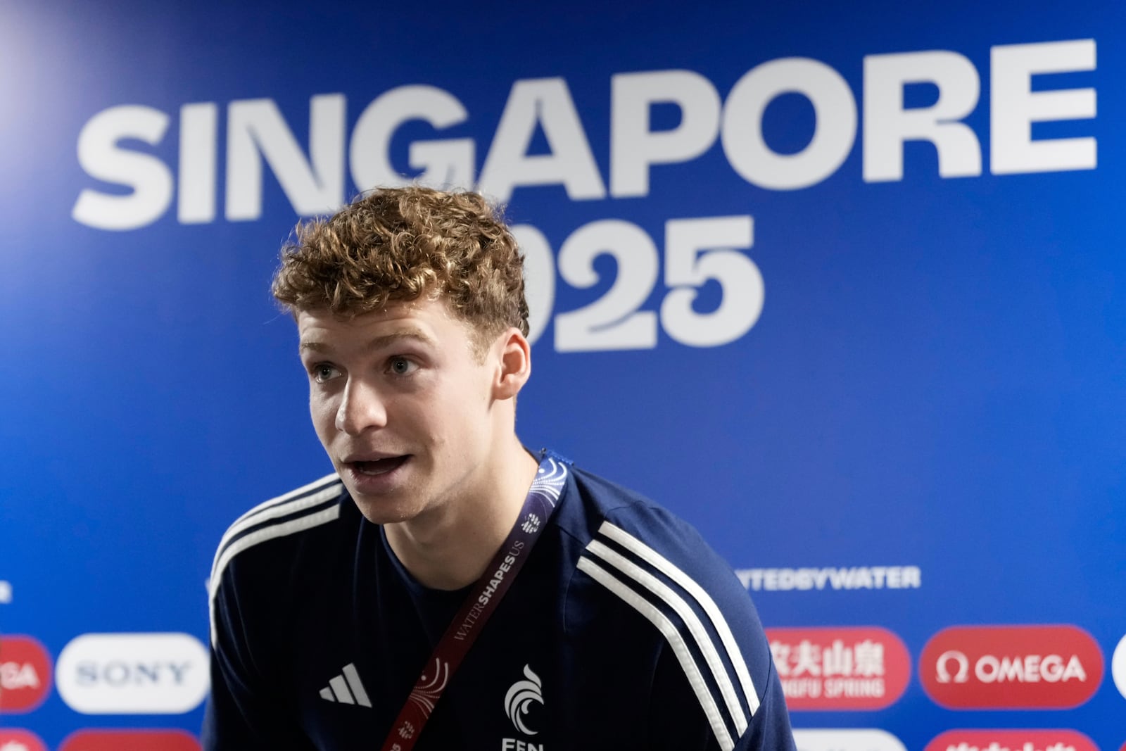 Leon Marchand from France arrives for the press conference at the World Aquatics Championships in Singapore, Saturday, July 26, 2025. (AP Photo/Lee Jin-man)