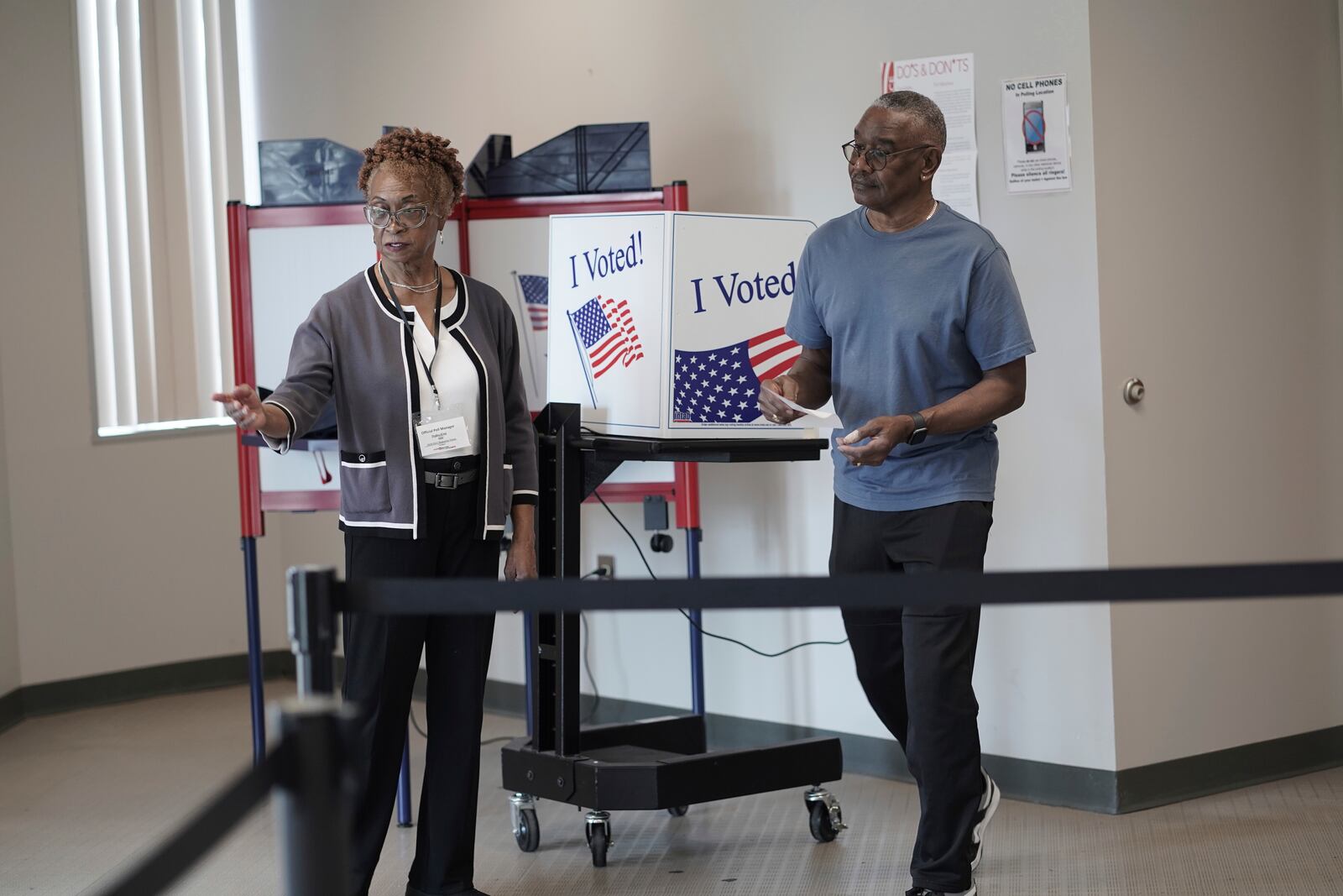 FILE - Joseph Clarkson Sr., 72, right, takes his ballot to a scanner during the South Carolina Democratic primary at a Richland County early voting site in Columbia, S.C., Jan. 26, 2024. (AP Photo/Serkan Gurbuz, File)