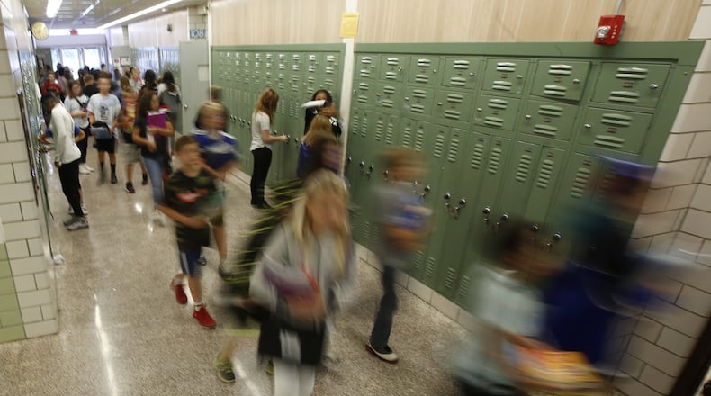 Students walk the halls of Warner Middle School in Xenia. TY GREENLEES / STAFF