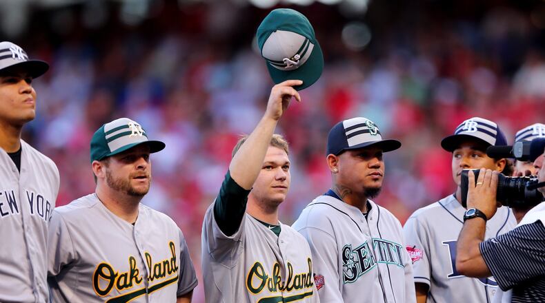 Oakland Athletics pitcher Sonny Gray, center, waves to the crowd prior to the 86th MLB All-Star Game at the Great American Ball Park on July 14, 2015 in Cincinnati, Ohio. (Photo by Elsa/Getty Images)