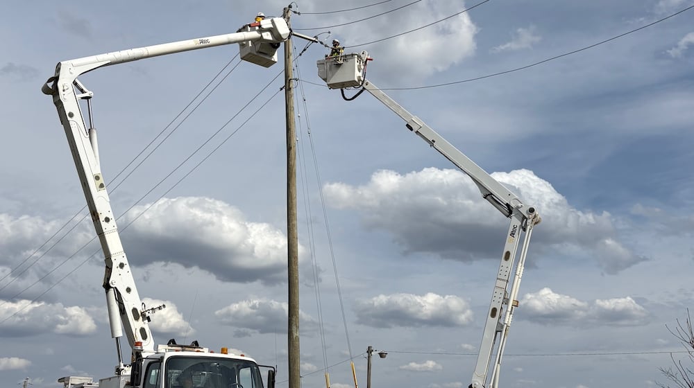 Crews work on a utility pole after thunderstorms and high winds March 11-16, 2026. AES / PROVIDED