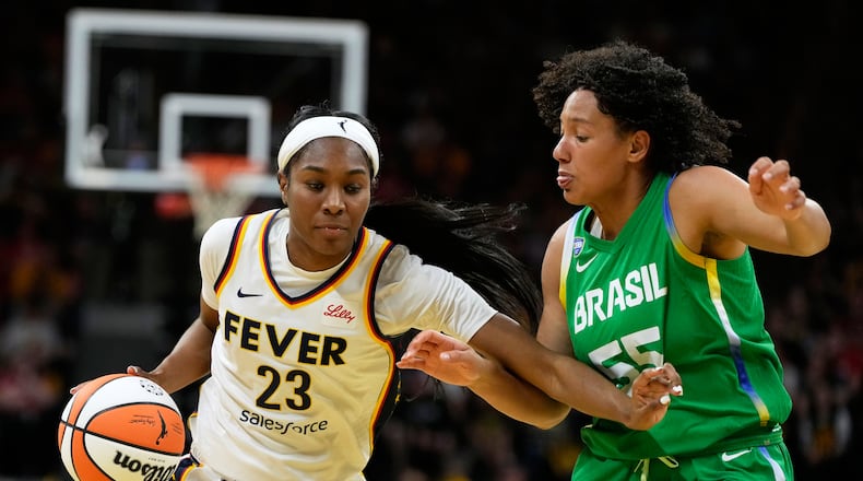 Indiana Fever guard Bree Hall (23) drives to the basket past Brazil forward Taissa Queiroz (55) during the second half of an exhibition women's basketball game, Sunday, May 4, 2025, in Iowa City, Iowa. (AP Photo/Charlie Neibergall)