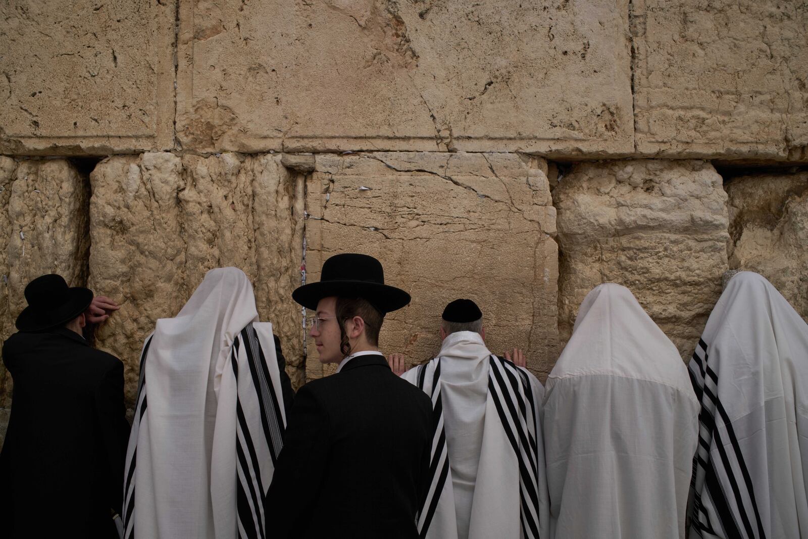 Covered in prayer shawls, Jewish men of the Cohanim Priestly caste participate in a blessing during the holiday of Passover, at the Western Wall, the holiest site where Jews can pray, in the Old City of Jerusalem, Tuesday, April 15, 2025. (AP Photo/Leo Correa)