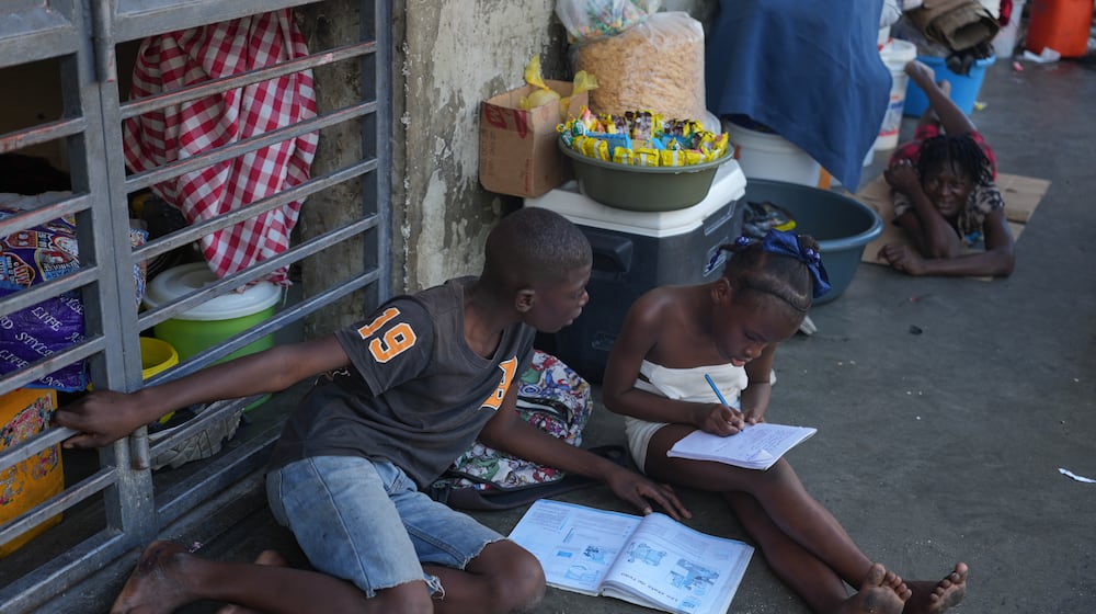 Children do their homework at a shelter for families displaced by gang violence in Port-au-Prince, Haiti, Tuesday, Jan. 27, 2026. (AP Photo/Odelyn Joseph)