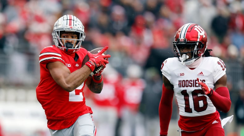 Ohio State wide receiver Emeka Egbuka, left, makes a catch in front of Indiana defensive back Jordan Grier during the second half of an NCAA college football game Saturday, Nov. 12, 2022 in Columbus, Ohio. Ohio State won 56-14. (AP Photo/Paul Vernon)