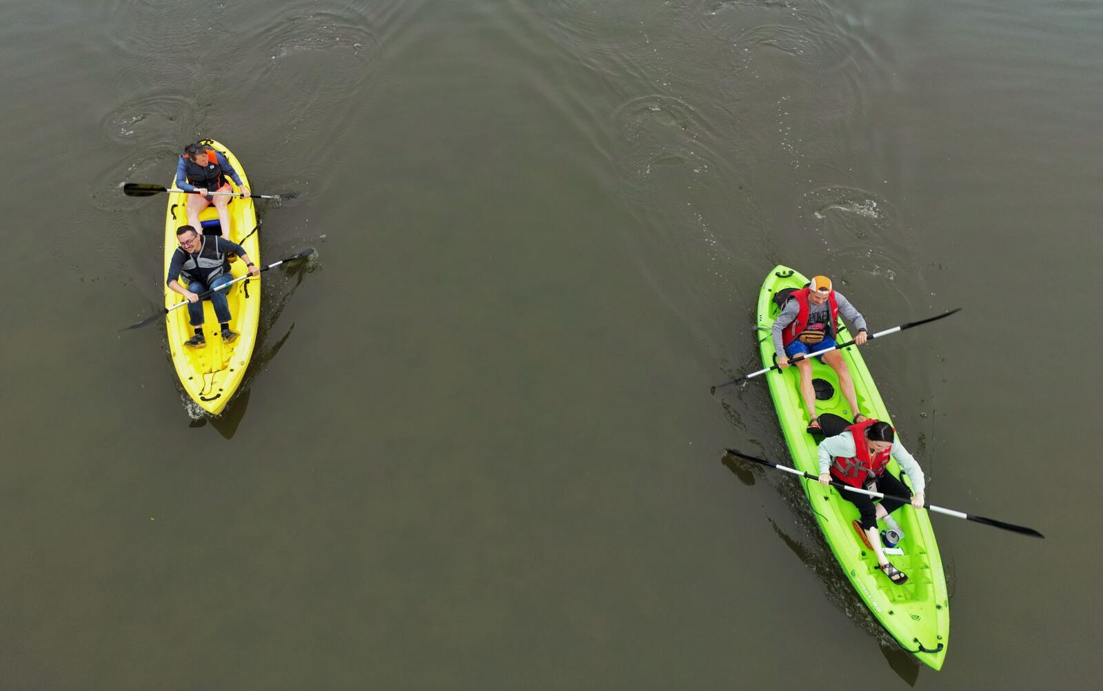 Jacob Stone-Welch and Lauren Nelson, left, and Otto Bohn and Mallory Greenham, right, were part of a group of about 20 people canoed and kayaked on the Great Miami River during a "Paddle to Work Day" event on Friday, June 23, 2023, in Hamilton. The outing was a collaborative effort between the city, The YMCA and the Great Miami Rowing Center. The groups took off from YMCA Camp Campbell Gard and paddled to the Great Miami Rowing Center dock near the High Main Bridge. NICK GRAHAM/STAFF