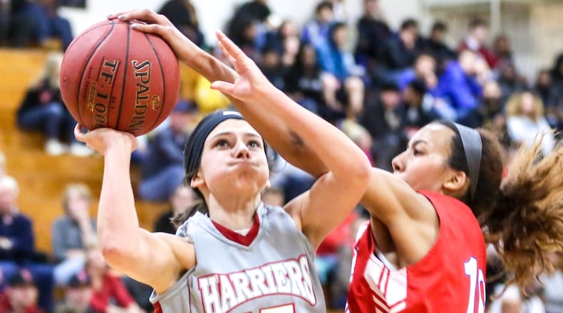 Miami Hamilton guard Sarah Merrill (15) has her shot blocked by Miami Middletown’s Braelyn Bean (10) during Wednesday night’s game at MUH. GREG LYNCH/STAFF