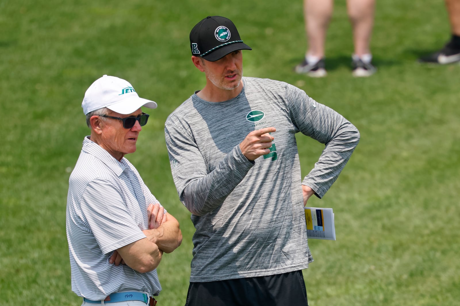 New York Jets owner Woody Johnson, left, and general manager Darren Mougey, right, during practice at NFL football minicamp, Wednesday, June 11, 2025, in Florham Park,N.J. (AP Photo/Noah K. Murray)