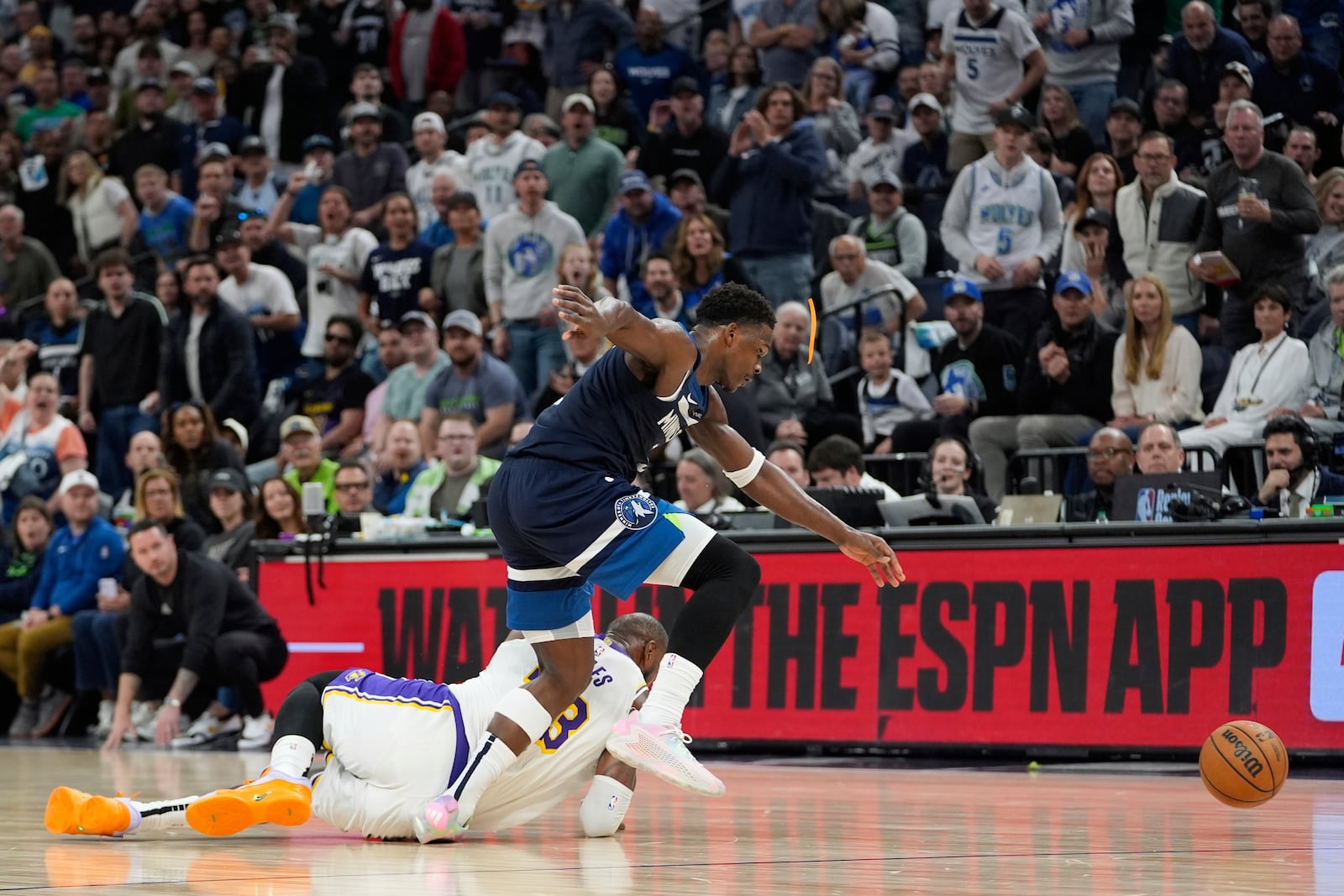 Minnesota Timberwolves guard Anthony Edwards (5) and Los Angeles Lakers forward LeBron James (23) collide while trying to gain possession of the ball during the first half of Game 4 of an NBA basketball first-round playoff series, Sunday, April 27, 2025, in Minneapolis. (AP Photo/Abbie Parr)