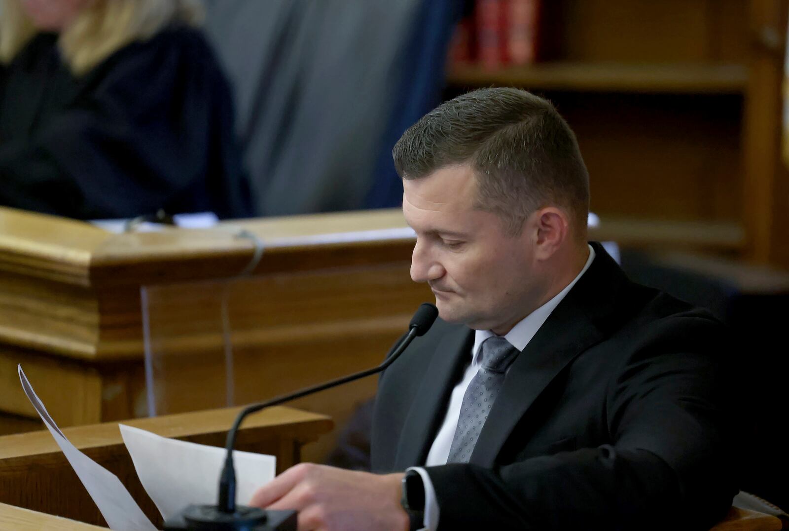Massachusetts State Police Sgt. Yuriy Bukhenik looks over documents while testifying during the Karen Read murder trial in Norfolk Superior Court in Dedham, Mass., Friday, May 9, 2025. (Mark Stockwell/The Sun Chronicle via AP, Pool)