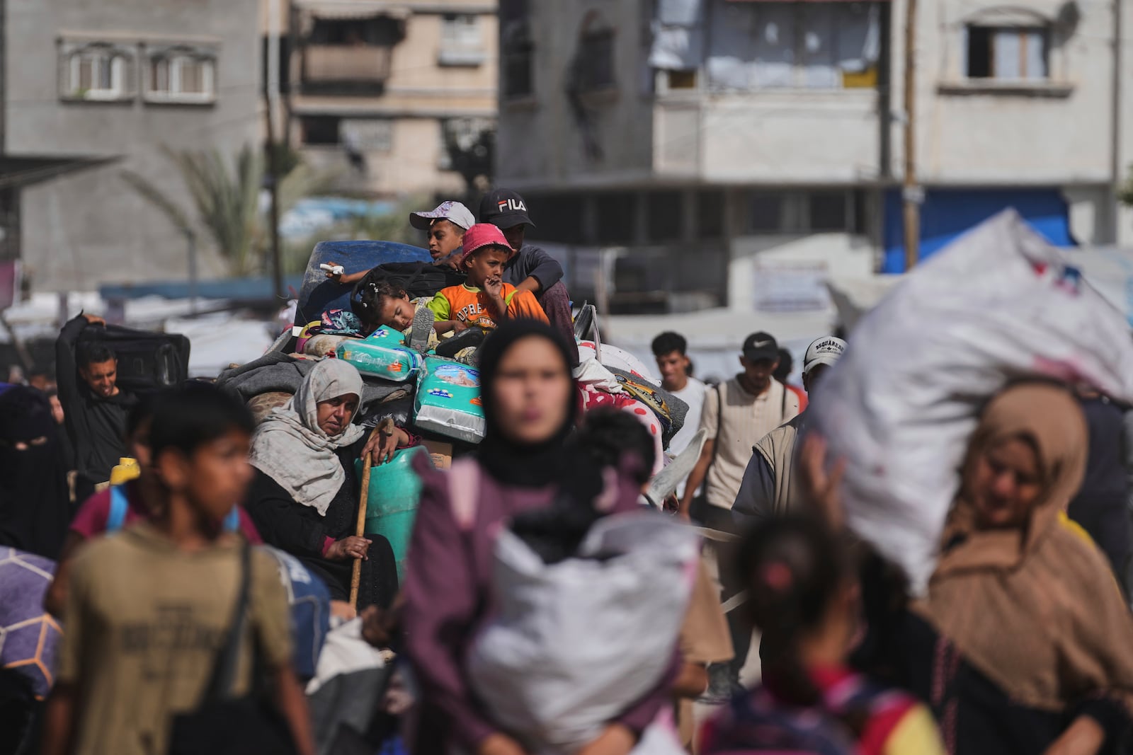 Displaced Palestinians flee from Khan Younis, Gaza, amid the ongoing Israeli military offensive in the area, on Monday, May 19, 2025. (AP Photo/Abdel Kareem Hana)