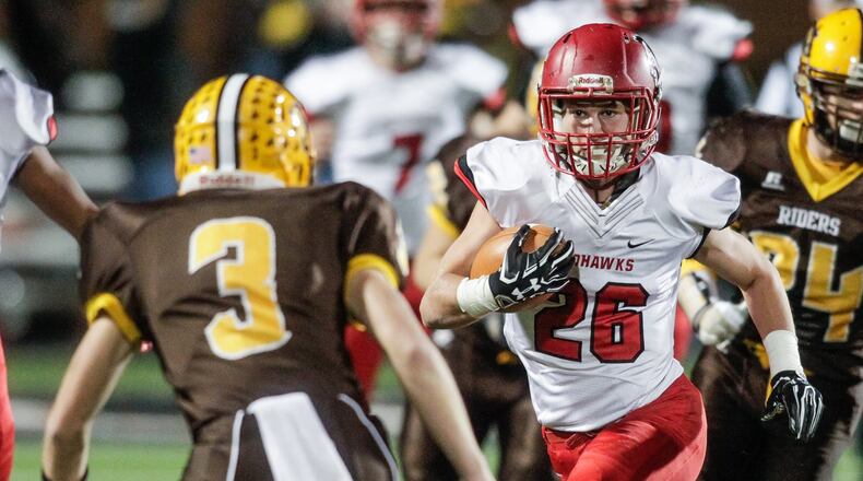 Madison fullback Cameron Svarda carries the ball as West Jefferson’s Zach Graham tries to stop him during the Division V, Region 20 final at Beavercreek on Nov. 17, 2017. The Mohawks won 42-7. NICK GRAHAM/STAFF