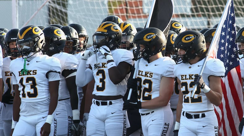 Centerville players, including Reggie Powers (3), wait to take the field before a game at Dublin Coffman on Aug. 25, 2023. David Jablonski/Staff