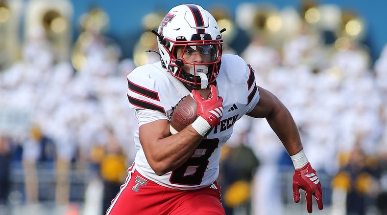 Texas Tech running back Cameron Dickey (8) runs against West Virginia during the first half of an NCAA college football game Saturday, Nov. 29, 2025, in Morgantown, W.Va. (AP Photo/Kathleen Batten)