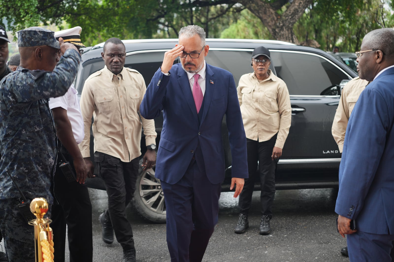 Haitian Prime Minister Alix Didier Fils-Aimé, center, salutes as he arrives for a ceremony marking the end of the presidential council in Port-au-Prince, Haiti, Saturday, Feb. 7, 2026. (AP Photo/Odelyn Joseph)