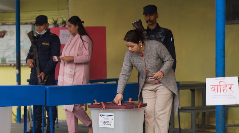 A woman casts her vote at a polling station for the parliamentary election in Kathmandu, Nepal, Thursday, March 5, 2026. (AP Photo/Niranjan Shrestha)