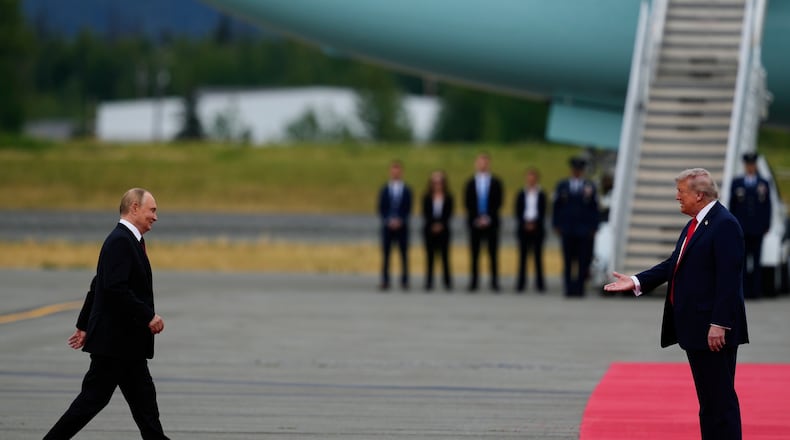President Donald Trump greets Russia's President Vladimir Putin Friday, Aug. 15, 2025, at Joint Base Elmendorf-Richardson, Alaska. (AP Photo/Julia Demaree Nikhinson)