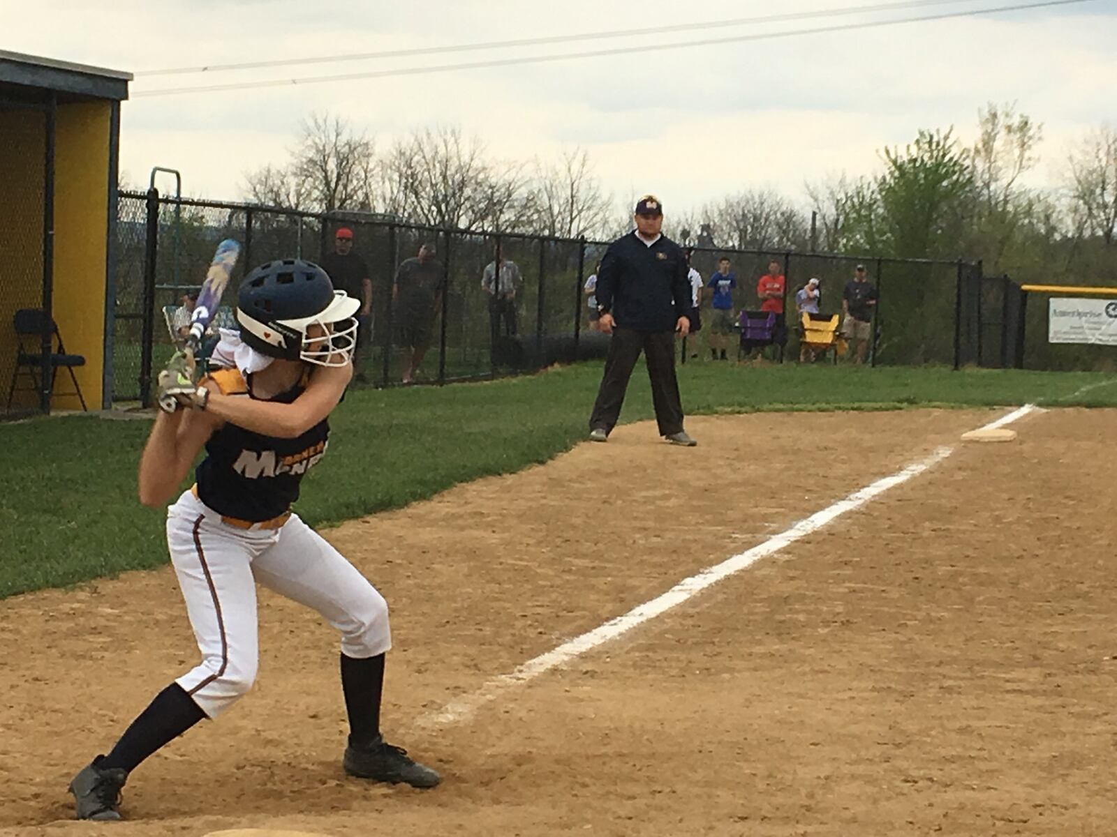 Monroe’s Shelby York gets ready to swing as assistant coach J.C. Kellis watches from the third-base coaching box during Thursday’s game against Bellbrook at Monroe. RICK CASSANO/STAFF