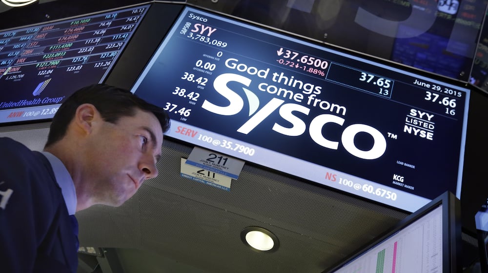 FILE - Specialist John McNierney works at the post that handles Sysco, on the floor of the New York Stock Exchange, Monday, June 29, 2015. (AP Photo/Richard Drew, file)