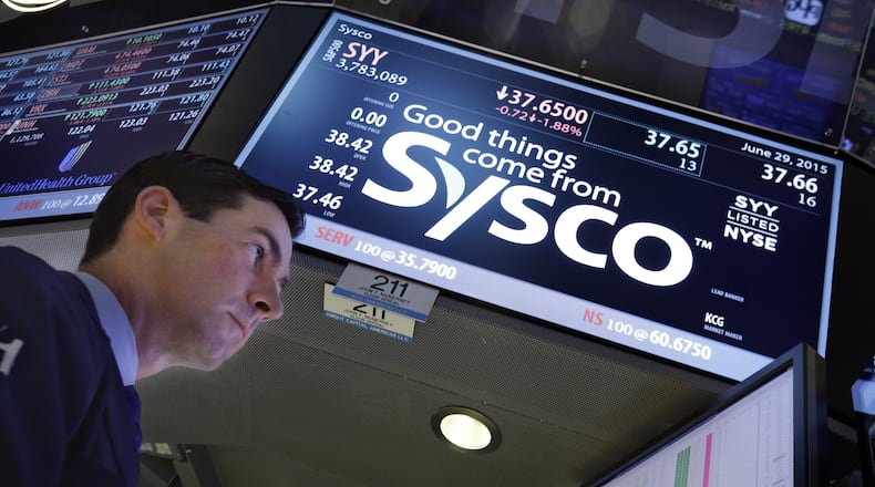 FILE - Specialist John McNierney works at the post that handles Sysco, on the floor of the New York Stock Exchange, Monday, June 29, 2015. (AP Photo/Richard Drew, file)