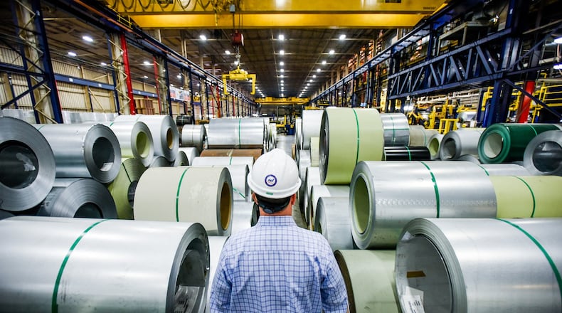 John Wallace, vice president of quality and technical systems at NCI Group, Inc. walks between coils of steel that are lined up and ready to be coated at Metal Coaters Middletown location, a coil coating facility for NCI Building Systems. Oct. 7 is Manufacturing Day and Metal Coaters is hosting an event at their facility as part of the Chamber of Commerce Serving Middletown, Monroe & Trenton’s festivities for the day that include speakers, lunch and tours of the facility. NICK GRAHAM/STAFF