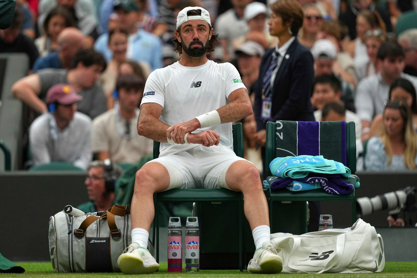 Jordan Thompson of Australia rests on his chair during his men's singles fourth round match against Taylor Fritz of the U.S. at the Wimbledon Tennis Championships in London, Sunday, July 6, 2025.(AP Photo/Joanna Chan)