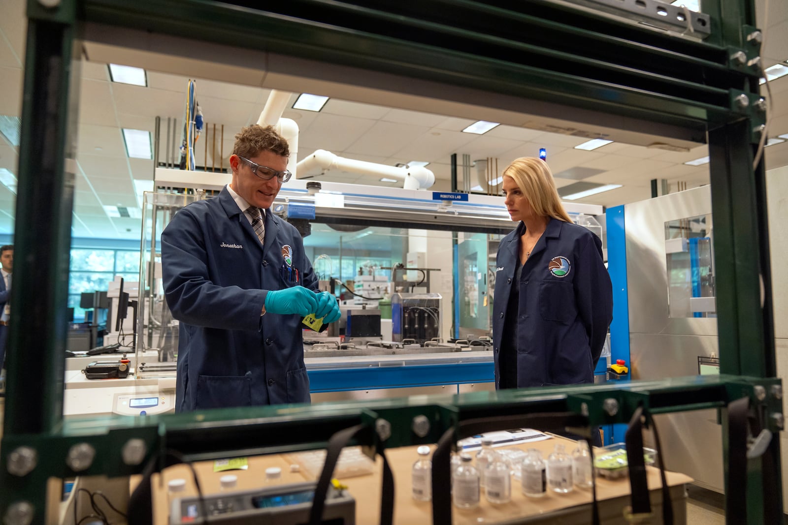 Attorney General Pam Bondi, right, watches as Jonathan Dumke, left, a senior forensic chemist with the Drug Enforcement Administration, demonstrates the use of a test strip used to detect the presence of fentanyl at a DEA research laboratory on Tuesday, April 29, 2025, in Northern Virginia. (AP Photo/Mark Schiefelbein)