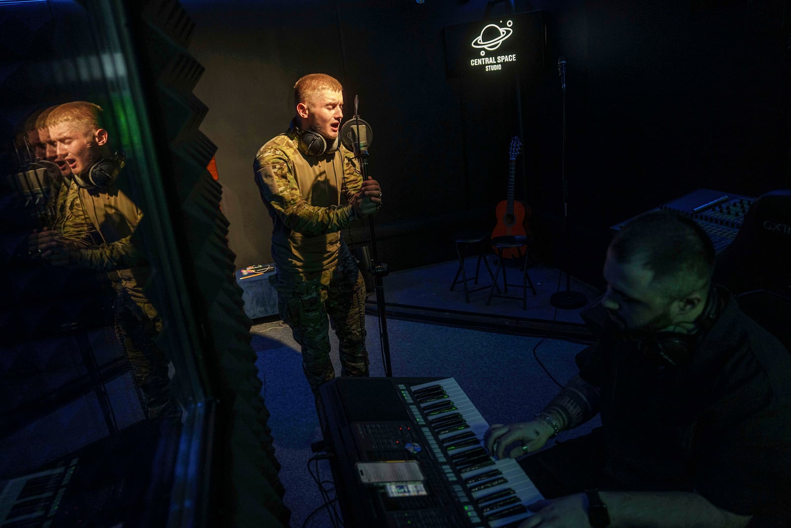 Ukrainian soldier Denys Zalizko, 21, sings a song at a recording studio in Kyiv, Ukraine, Tuesday, July 15, 2025. (AP Photo/Evgeniy Maloletka)